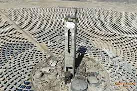 A power tower solar concentrator in a field of mirrors in the desert.