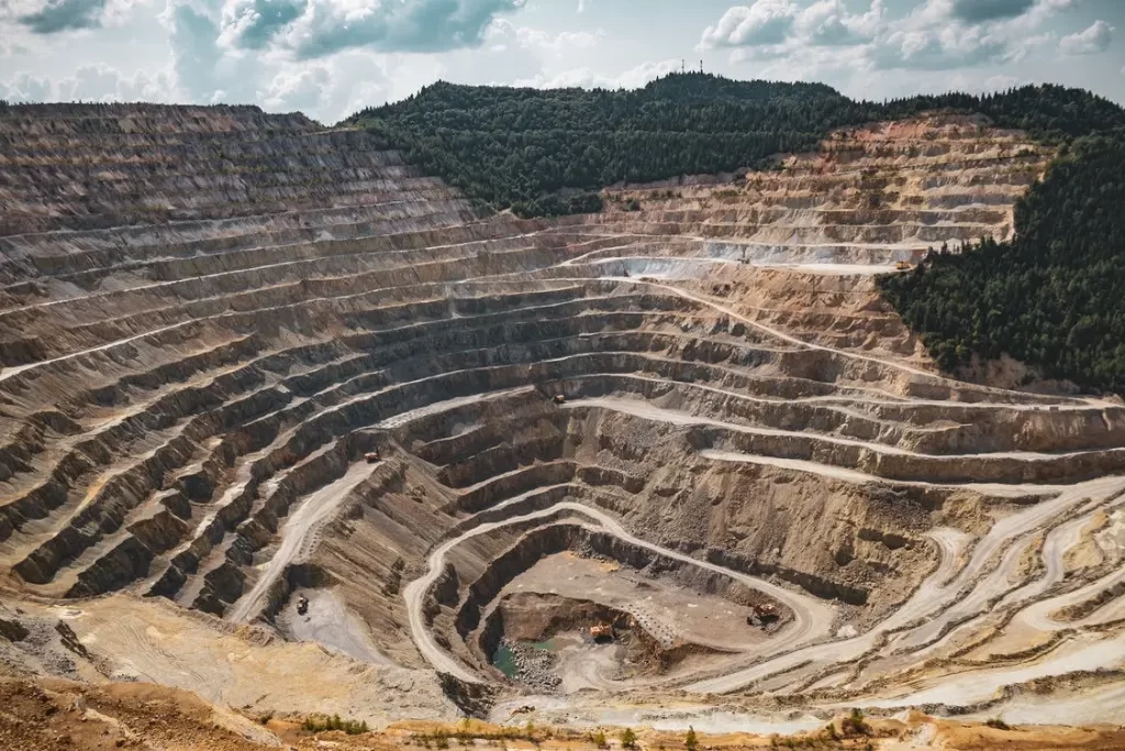 This strip mine that has cut away hills and created a deep pit which is a prime example of environmental degradation 