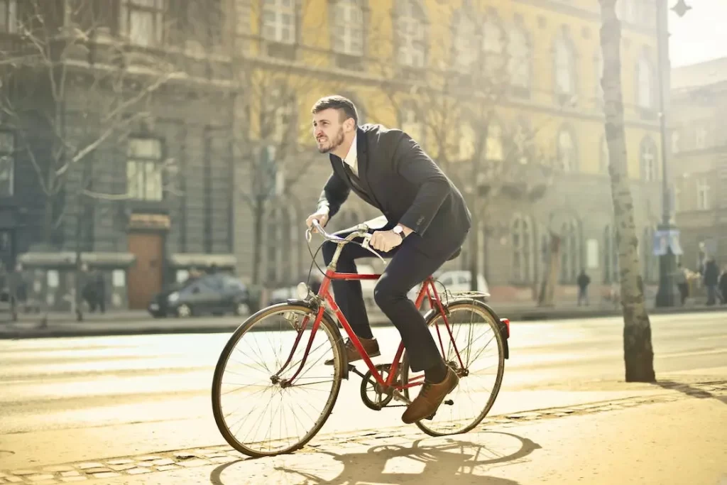 A businessman helping to fight air pollution by riding his bicycle through the city to work in an office. 