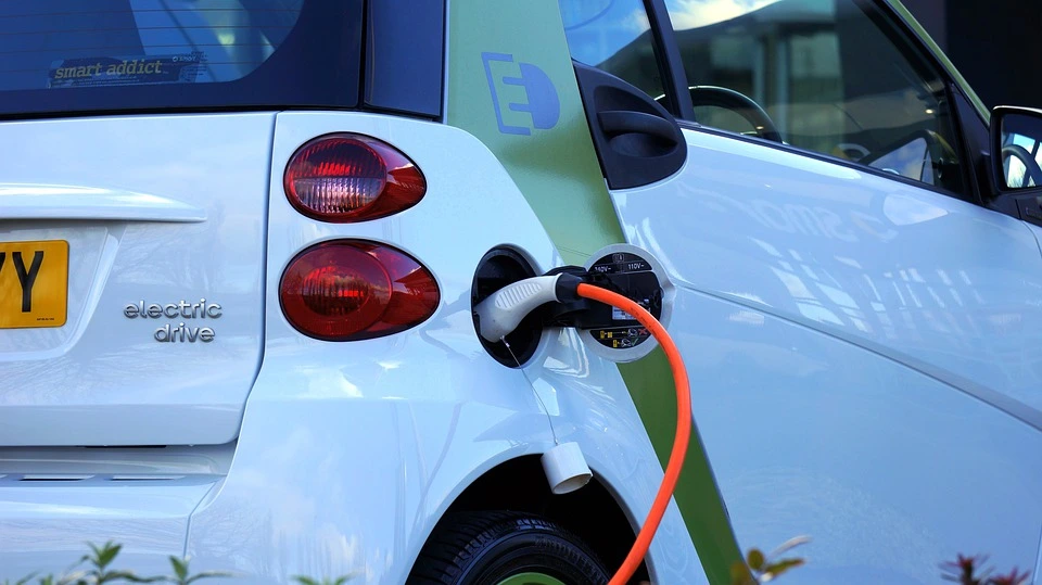 An electric vehicle at a charging station to recharge the lithium-ion battery bank.