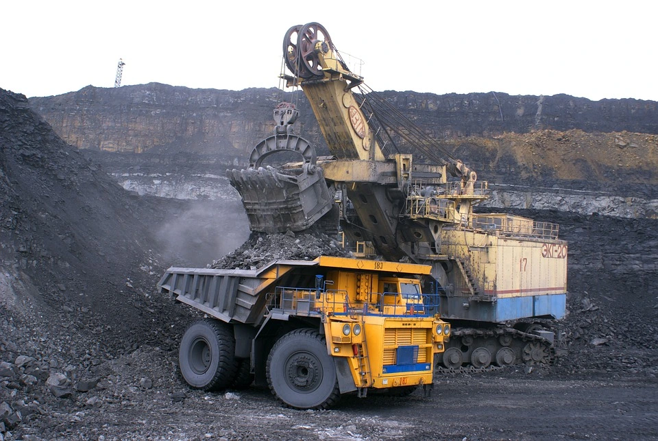 Heavy machinery in a coal mine that is supplying coal to make solar panels.
