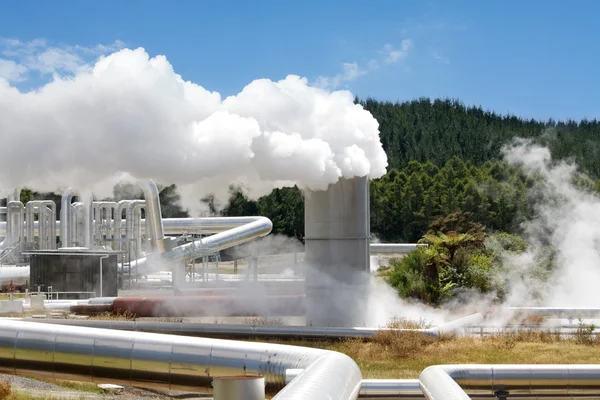 A geothermal power plant with a lot of steam coming from the generator turbine.