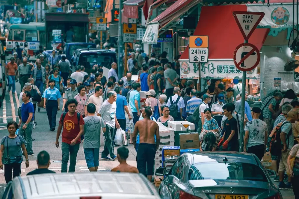 Hong Kong streets are full of people buying, selling, and commuting.