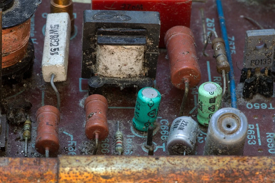 An old circuit board that's rusty from being left in the outdoors to leach toxic chemicals into the enviroment.
