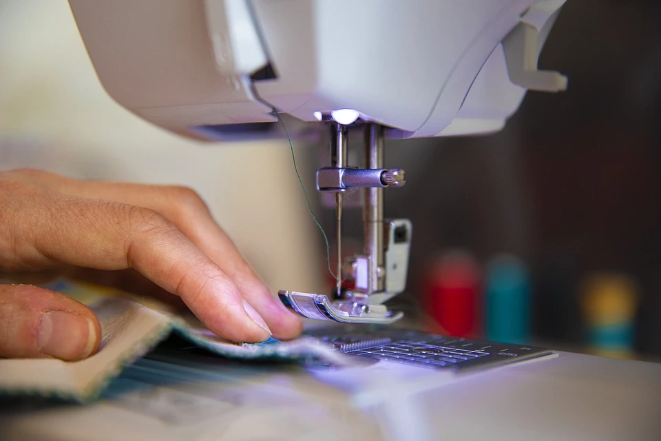 A seamstress sewing new clothing from recycled fabric. This is just one job created by the recycled fabric industry.