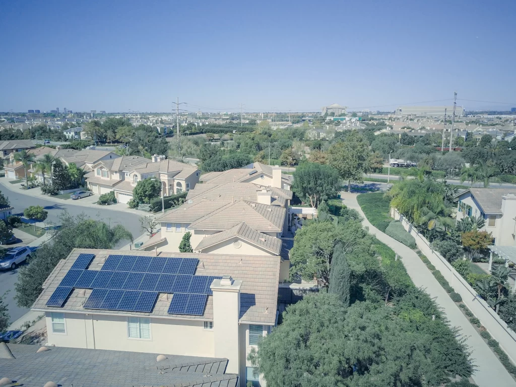 A home with solar panels on the roof to help reduce dependence on the electricity grid.