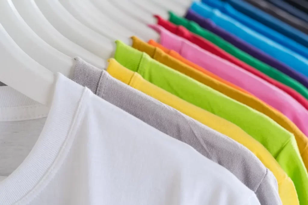 A rack of tee shirts in all colors made from recycled fabric.