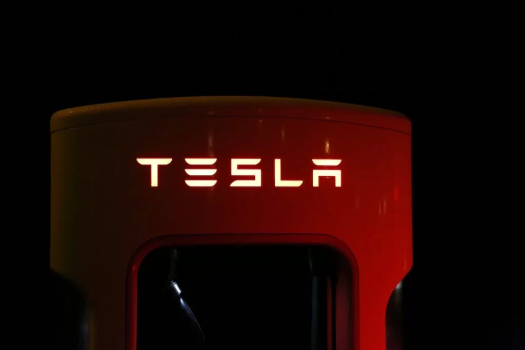 Tesla charging station illuminated in the dark. Tesla's car batteries are recyclable.