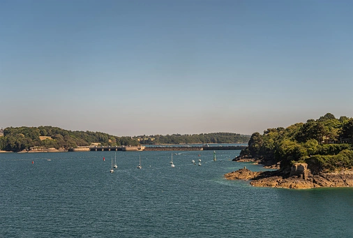 A tidal barrage that completely encloses an estuary to harvest the tidal energy for electricity.