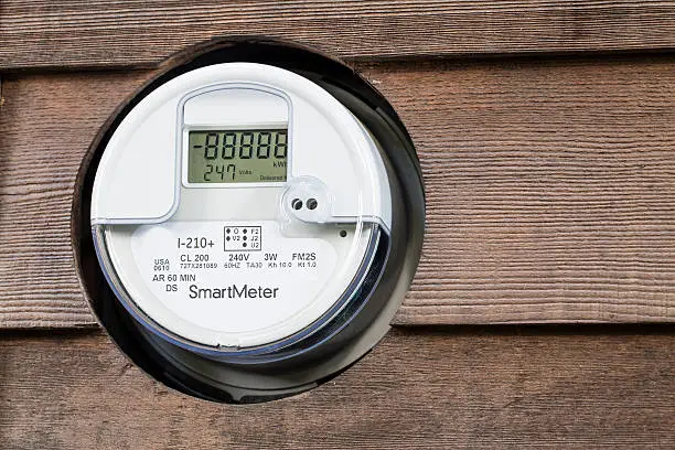 A smart meter installed on a house tracks the amount of electricity used to power the house from the electricity grid.